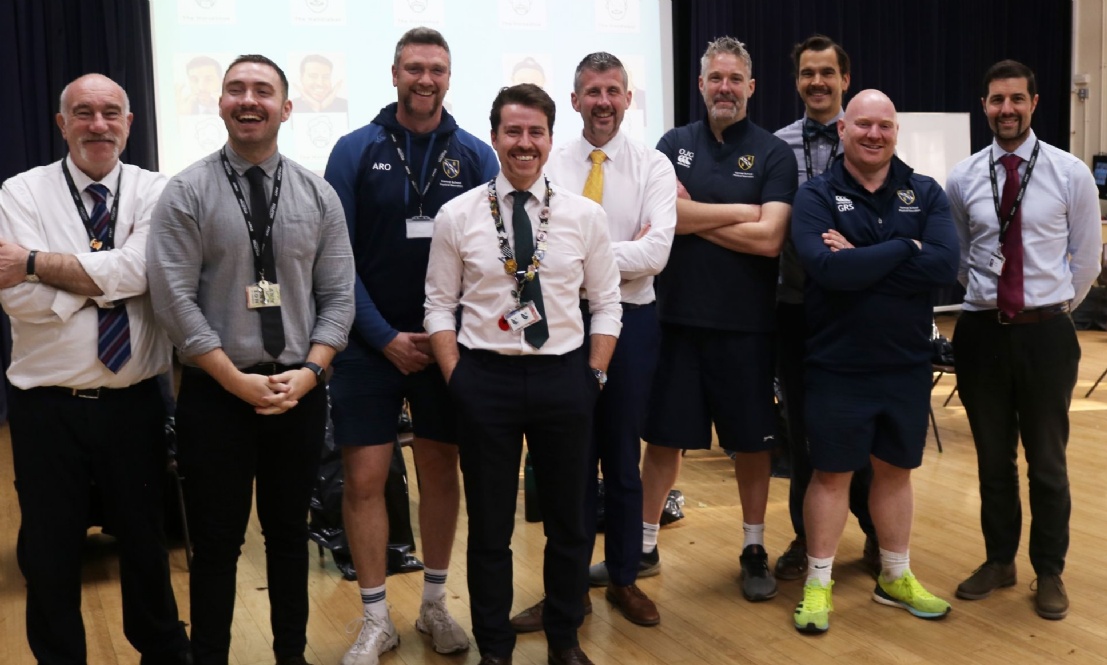 Members of male staff after they have had their beards shaved for Movember charity event